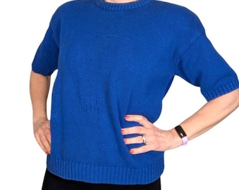 May include: A royal blue short-sleeved sweater with a textured design.
