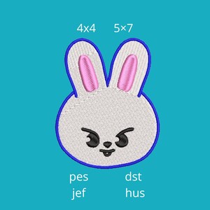 May include: Embroidered bunny face with pink inner ears, outlined in blue, on a teal background. The design includes the text "4x4" and "5x7" above the bunny, and "pes", "jef", "dst", and "hus" below.