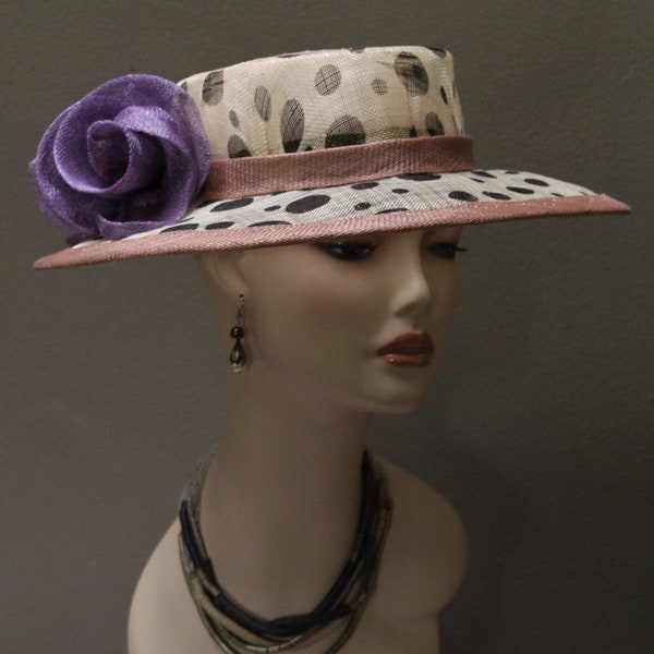 New women's Boater Style Hat by Alexander & Hallatt in Beige with Black Polka dots, edged in Sand Sinamay with Lilac Sinamay flower accents