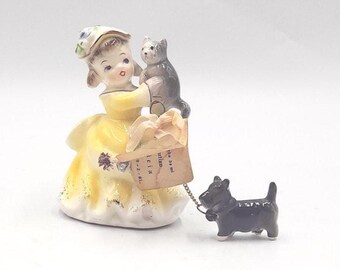 Lady Figurine holding a cat with a Scottish Terrier on a leash - La Abeja Sabana Grande Sticker
