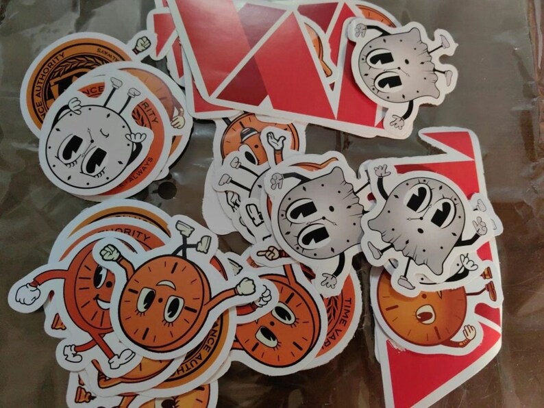 May include: A collection of colorful stickers featuring cartoon clocks with different expressions. The stickers are on a white background and some have the words "Time Always" and "Time Waits for No One" on them.