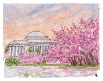 May include: Watercolor painting of the Jefferson Memorial with cherry blossoms in full bloom. The monument is white with a domed roof and columns. Pink blossoms frame the building, reflecting in the water below. The sky is a blend of pink, orange, and blue.