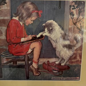 May include: A vintage illustration depicts a young person in a red dress seated on a striped stool, writing on a slate. A fluffy cat with gray and white fur stands on a red sled, reaching out to the slate. The artwork has a nostalgic, storybook feel.