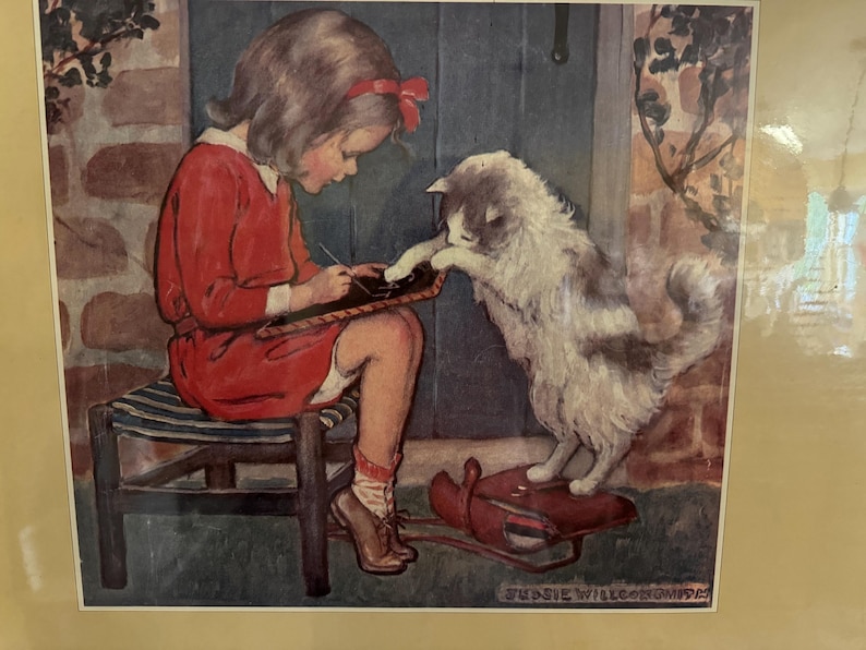 May include: A vintage illustration depicts a young person in a red dress seated on a striped stool, writing on a slate. A fluffy cat with gray and white fur stands on a red sled, reaching out to the slate. The artwork has a nostalgic, storybook feel.
