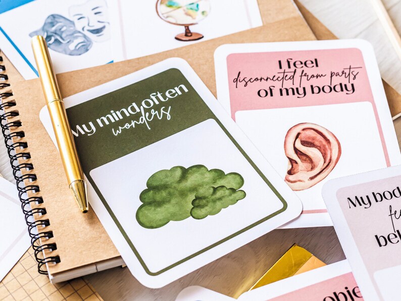 May include: A set of cards with illustrations and text. The cards feature phrases like "My mind often wonders" and "I feel disconnected from parts of my body".