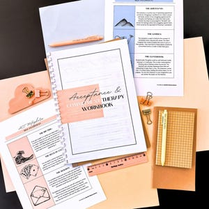 various items related to therapy and self-care, including a notebook, a ruler, a pen, a stapler, and some papers.