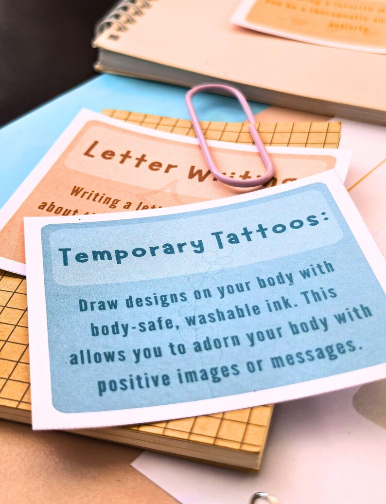 a close-up view of a temporary tattoo card with instructions on how to draw designs on one's body using washable ink.