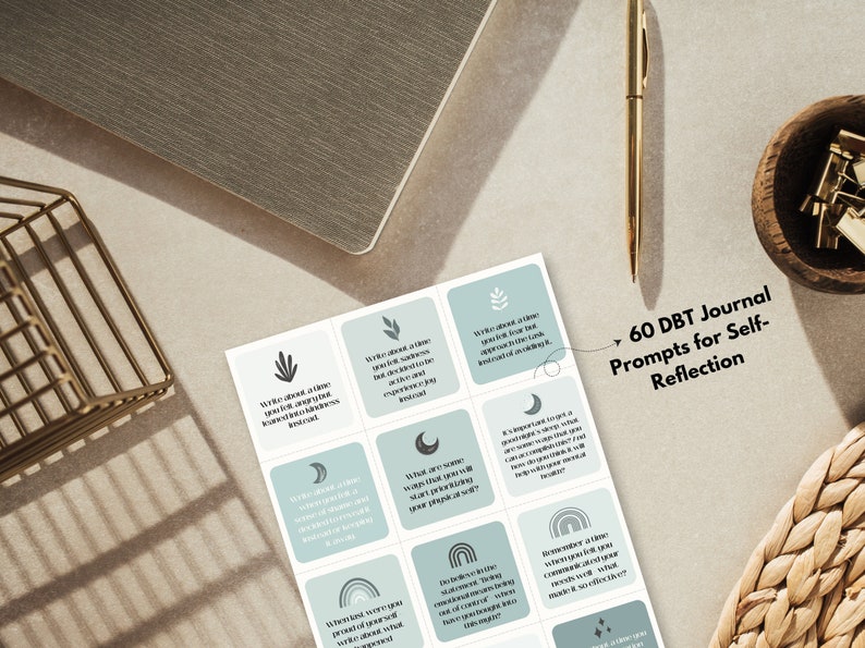 May include: A set of 60 DBT journal prompts for self-reflection. The cards are printed on white paper with a light blue background and feature various icons and text. The text on the cards is in black. The cards are arranged in a grid pattern. The text on the cards reads: "60 DBT Journal Prompts for Self-Reflection".