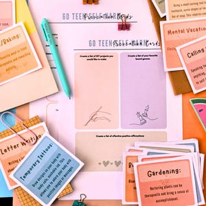 various items related to a "Go Teen Positive" activity, including a pen, a sheet of paper, and several cards with different prompts and instructions.