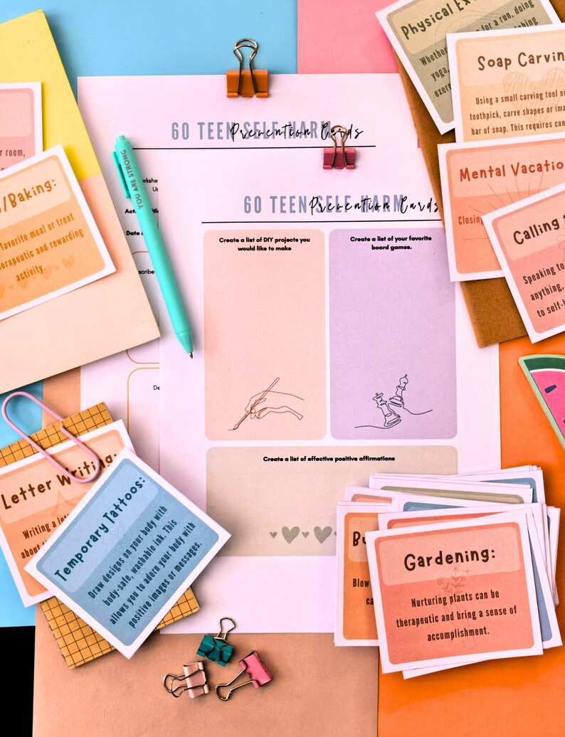 various items related to a "Go Teen Positive" activity, including a pen, a sheet of paper, and several cards with different prompts and instructions.