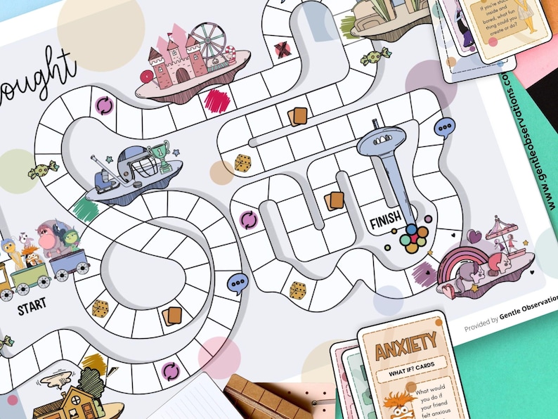 May include: A colorful board game with a whimsical design, featuring a path with illustrations of a castle, ferris wheel, and a spaceship. The game includes cards with the word "ANXIETY" and the text "WHAT IF CARDS".