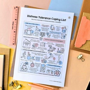 May include: A printed coping list titled "Distress Tolerance Coping List" with practical strategies to manage emotional overwhelm. The list includes sections on connection, creative distraction, and physical activity. A peach-colored pen with the text "IT'S OKAY TO MAKE MISTAKES" is also visible.
