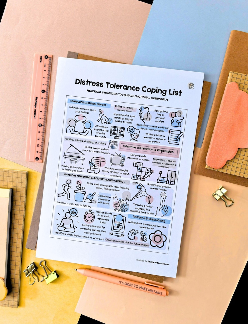 May include: A printed coping list titled "Distress Tolerance Coping List" with practical strategies to manage emotional overwhelm. The list includes sections on connection, creative distraction, and physical activity. A peach-colored pen with the text "IT'S OKAY TO MAKE MISTAKES" is also visible.