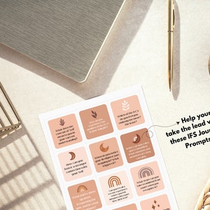 May include: A set of IFS Journal Prompts with a neutral color palette. The prompts are on square cards with icons and questions. A gold pen, a notebook, and a small gold wire basket are also in the image. The text reads: "Help your Self take the lead with these IFS Journal Prompts."