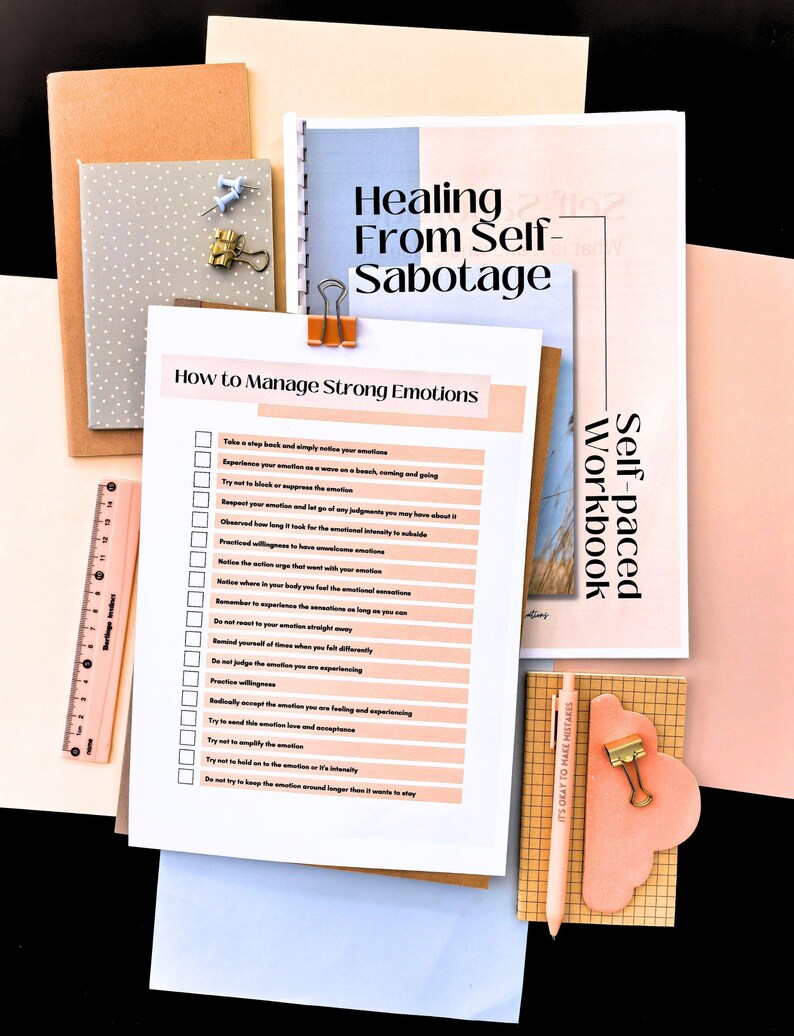 a variety of items, including a clipboard with a list of steps for managing strong emotions, a self-paced workbook, a ruler, a pen, and a small cloud-shaped object.