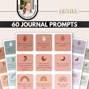 May include: A set of 60 journal prompts printed on rectangular cards in shades of terracotta, sage green, and lavender. Each card features a unique icon like a moon, rainbow, or leaf, and a written question to encourage self-reflection.