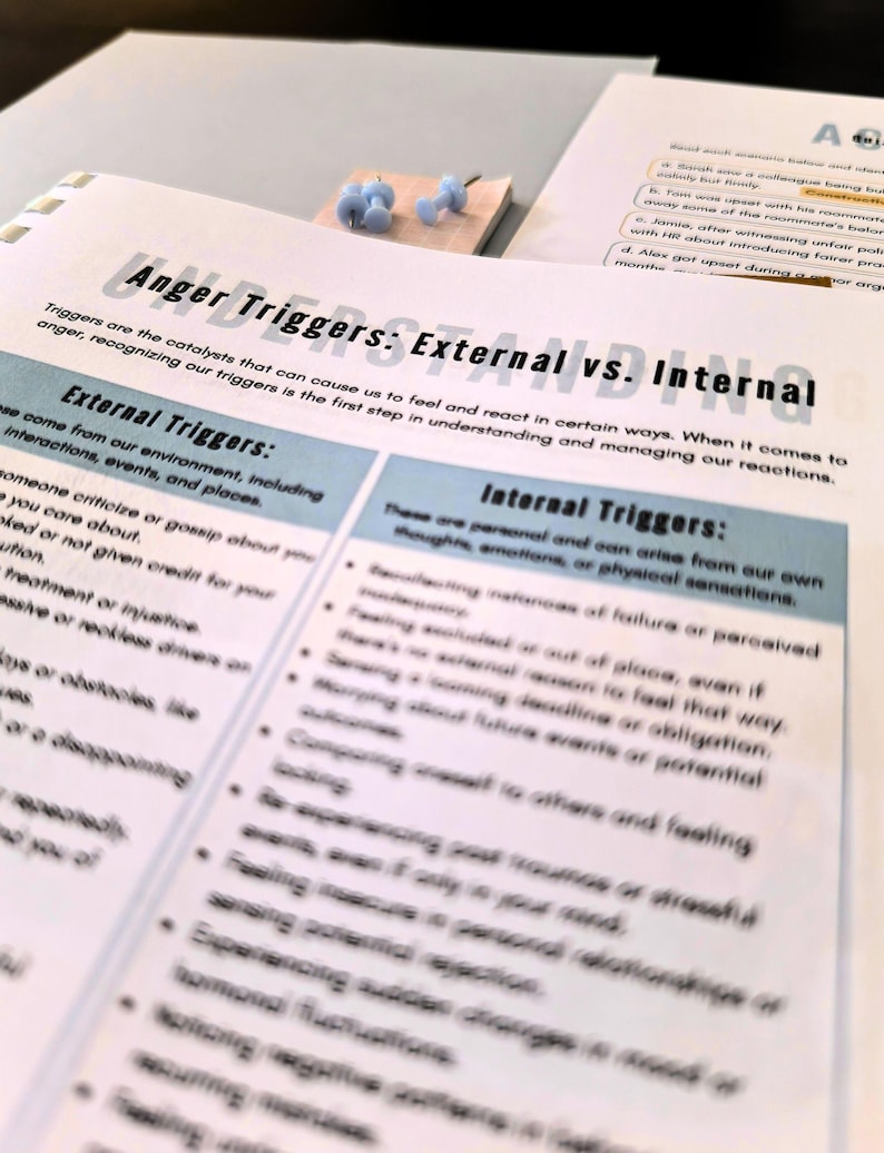 a close-up view of a printed document or worksheet with text and bullet points, with a small wooden block or object placed on top of it.