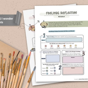 May include: Two worksheets titled "I Worry VS I Wonder" and "Feelings Reflection." The worksheets feature prompts to identify and reframe worries. A sketchbook, paintbrushes, and a pencil are also visible.