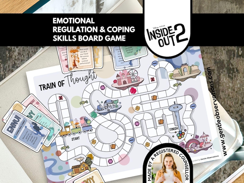 May include: A board game titled "Emotional Regulation & Coping Skills" with the text "Train of Thought." The game board features a winding path with illustrations of a train, a Ferris wheel, and other whimsical elements. Cards with words like "Ennui" and "Joy" are included.