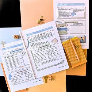 May include: A selection of printed worksheets and a notepad with a pen, with the text "BREAKING THE CYCLE: IDENTIFYING TRIGGERS." The worksheets are held together with gold binder clips and are on a light orange background.