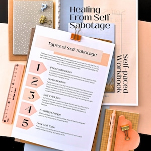 various items related to self-care and personal development, including a book titled "Healing from Self-Sabotage", a ruler, a pen, and a notebook.