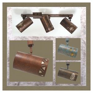 May include: Five track lighting fixtures with different designs. The fixtures are made of metal and have a rustic finish. The shades are cylindrical and have various patterns.