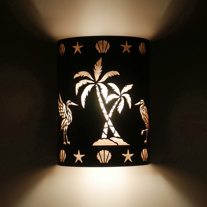 Nautical and Coastal style wall light for indoor and outdoor use featuring our cranes and palm tree design- night view