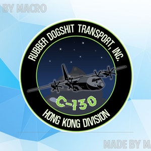 May include: Circular emblem featuring a black and green design with the text "RUBBER DOGSHIT TRANSPORT, INC." and "HONG KONG DIVISION." A C-130 aircraft is depicted against a starry night sky. The words "MADE BY MACRO" appear at the top and bottom.