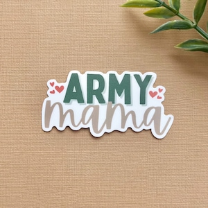 May include: A white sticker with the text "ARMY mama" in green and brown lettering. There are small red hearts on either side of the text.