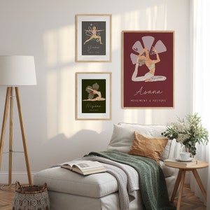 May include: Three framed yoga art prints hang on a white wall. The prints feature illustrations of yoga poses with text. The top print says "Yama" and the bottom print says "Niyama". The largest print says "Asana" and "Movement & Posture".