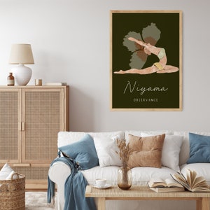May include: A framed art print featuring a yoga pose illustration. The artwork depicts a figure in a backbend, with the word "Niyama" and "Observance" in a script font. The background is a dark green, and the frame is light brown.