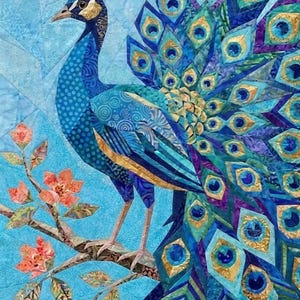 May include: A fabric quilt wall hanging featuring a peacock with a fanned tail of blue, teal, purple, and gold geometric patterns. The bird stands on a brown branch with orange flowers against a light blue background with angular stitching.