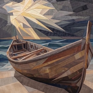 May include: A fabric wall hanging featuring a pieced quilt design of a wooden boat resting on a shore. The scene includes a dark, geometric sky with a bright, radiating sunburst pattern above a blue sea, constructed from various shades of brown, gray, and blue fabric segments.