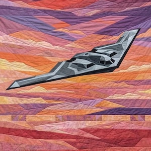May include: A quilted artwork featuring a stealth bomber aircraft soaring against a vibrant sunset. The aircraft is rendered in shades of gray, while the background showcases a gradient of orange, purple, and pink hues, creating a striking contrast.