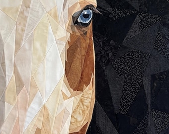 May include: A fabric quilt wall hanging featuring a geometric pieced horse head in shades of cream, tan, and brown with a bright blue eye. The background is composed of dark black and charcoal gray fabric pieces in a fragmented mosaic pattern.