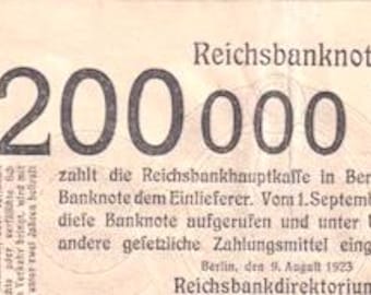 May include: A vintage Reichsbanknote, displaying the value "200 000 M" prominently. The note includes German text and the date "9. August 1923". The background is a faded, off-white colour.