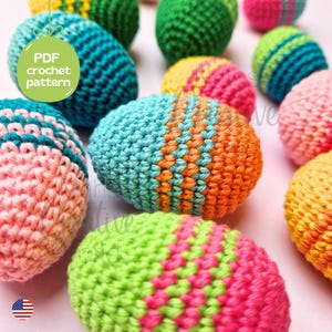 May include: A collection of colorful crocheted Easter eggs in various patterns, including pink, green, blue, orange, and yellow. The eggs are arranged on a white surface. PDF crochet pattern.