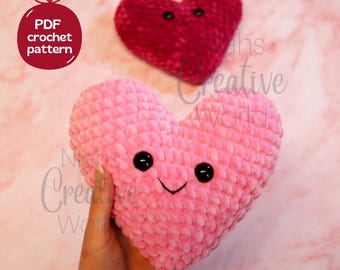 May include: Two crocheted heart-shaped plush toys with smiling faces. The larger heart is pink and the smaller heart is red.  PDF crochet pattern.