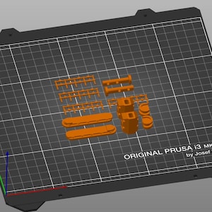 Peut inclure: Mod&egrave;le orange imprim&eacute; en 3D de pi&egrave;ces, comprenant des formes rectangulaires et cylindriques, dispos&eacute;es sur une grille noire. Le texte "ORIGINAL PRUSA i3 MK3 by Josef Prusa" est visible sur la grille.