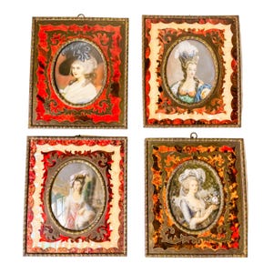 May include: Four ornate gold frames with red and white accents, each containing a miniature portrait of a woman in a white dress with a powdered wig. The portraits are set against a white background.