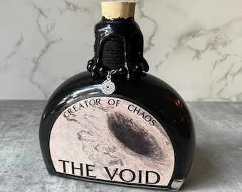 May include: Black glass bottle with a cork stopper and a label that reads "Creator of Chaos The Void".