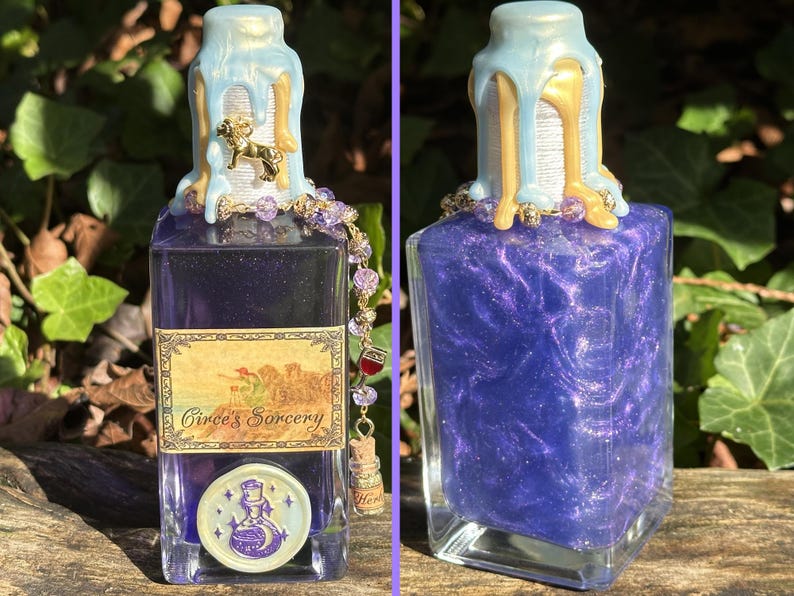 May include: A glass bottle with a purple liquid inside. The bottle has a blue and gold wax seal on the top and a label that reads "Circe's Sorcery".