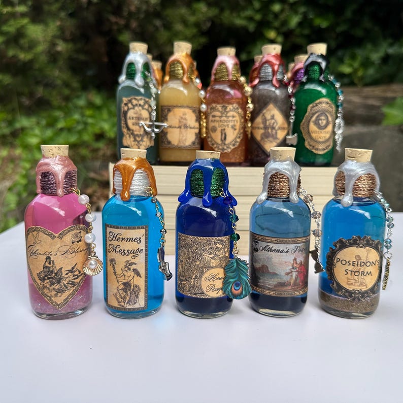 May include: A selection of decorative potion bottles with cork stoppers. The bottles contain colourful liquids, ornate labels, and decorative embellishments. Some labels include text such as "Hermes Message" and "Poseidon's Storm".