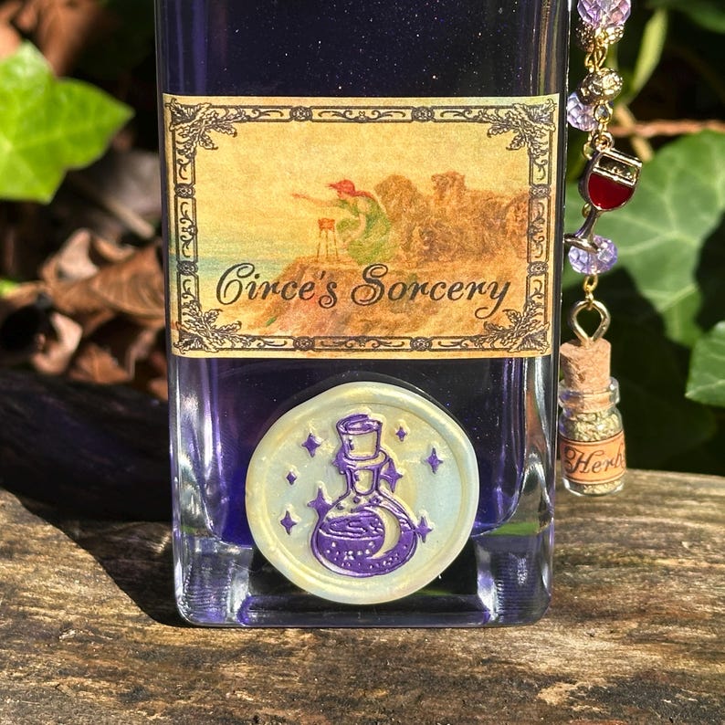 May include: A glass bottle with a purple liquid and a white wax seal. The bottle has a label that says "Circe's Sorcery". The bottle is decorated with a gold chain and a small glass vial with a cork stopper.