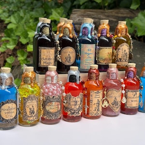 May include: A collection of decorative potion bottles with cork stoppers and ornate labels. The bottles feature colorful liquids and are adorned with gold-colored wax seals and charms. The labels include text such as "Poseidon's Storm" and "Aphrodite's Beauty."