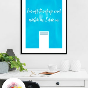 May include: A framed poster with a blue background and white text that reads "I'm off the deep end, watch as I dive in". A white rectangle with three horizontal lines is in the center of the poster.