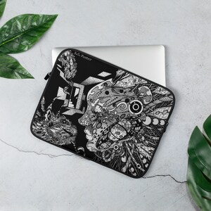 May include: Black laptop sleeve with a white and gray graphic design featuring a human face and a wolf. The design is intricate and detailed, with a variety of patterns and textures. The sleeve has a zipper closure and the artist's name, B.O. Foster, is printed on the front.