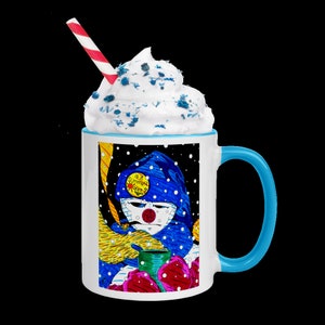 May include: White ceramic mug with a blue handle. The mug features a colorful illustration of a person wearing a blue hooded jacket and holding a cup. The text "Is it Summer Yet?" is on a yellow sun in the illustration. The mug has white whipped cream with blue sprinkles on top.