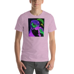 May include: A purple, green, and black graphic t-shirt featuring a stylized illustration of a person with a cat.