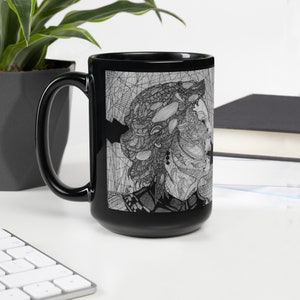 May include: Black ceramic mug with a white and black line drawing of a woman's face on one side. The woman's hair is styled in a large, intricate updo.